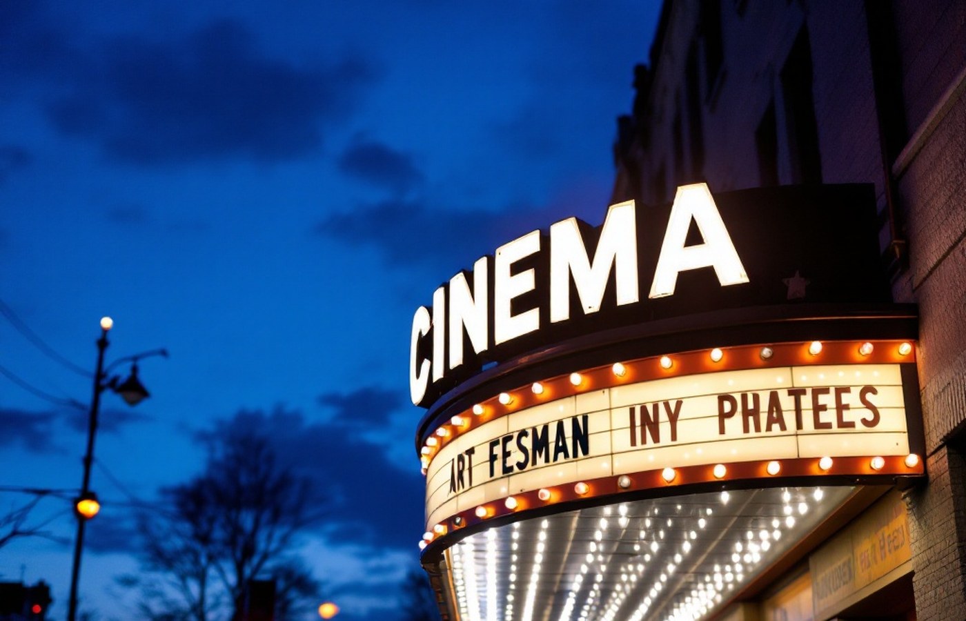 A cinema marquee glowing at night